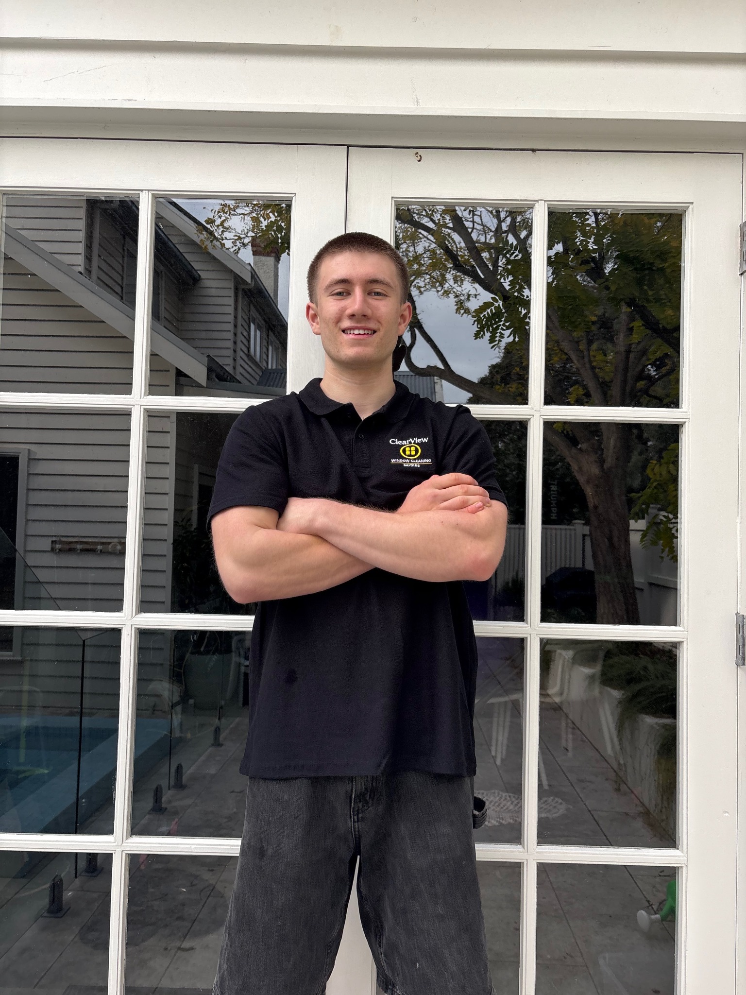 ClearView Bayside owner standing in front of cleaned glass doors